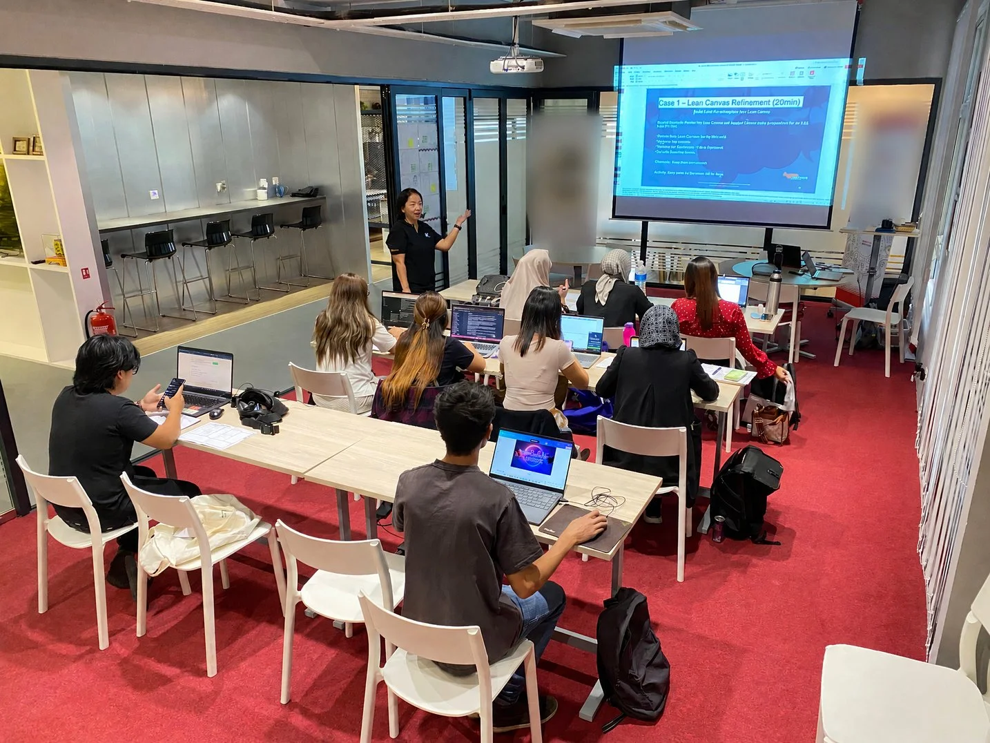 Participants working on laptops during an Algebra Technologies hands-on AI workshop